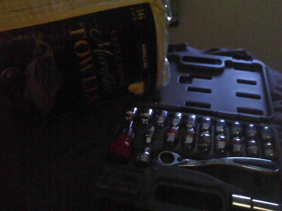 Tool kit with sockets and ratchet next to paper towels