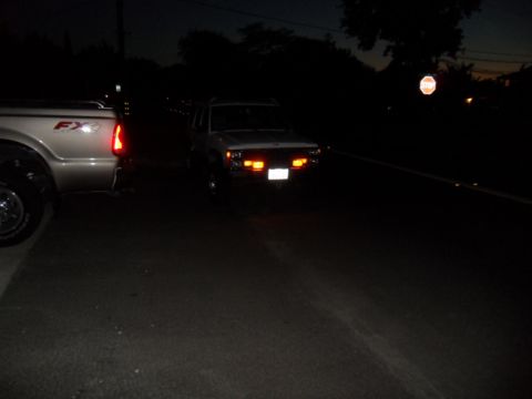 1994 Jeep Cherokee - A white 1994 Jeep Cherokee is seen at night with its hazard lights illuminated.