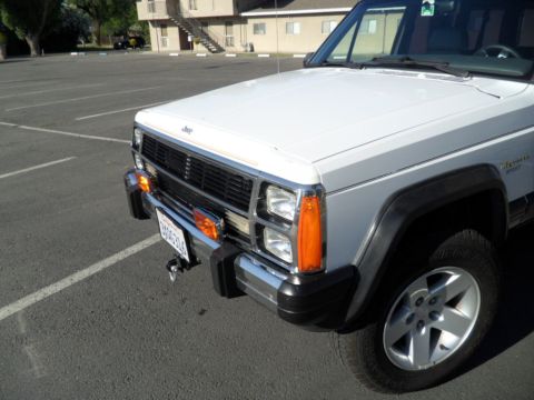 1994 Jeep Cherokee - Front view of a white 1994 Jeep Cherokee parked in a lot.