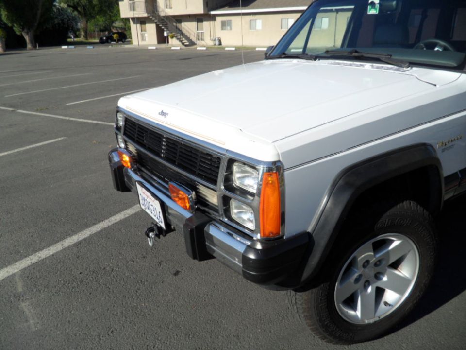 1994 Jeep Cherokee front corner showing grille, headlights, and bumper