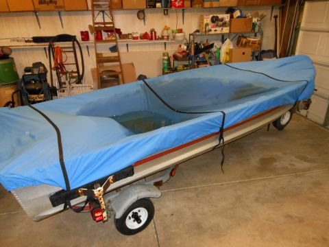 1996 Ford F-150 - Boat on trailer covered with blue tarp, stored inside a garage with shelves and tools.