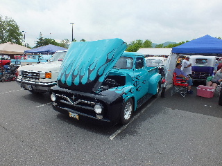 2013 Ford F-100 - Customized pickup truck with flame graphics displayed at a car show.