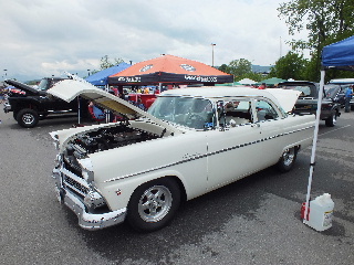 2013 Ford F-100 - A white 1956 Ford Fairlane Crown Victoria is displayed with its hood open at an outdoor car show.