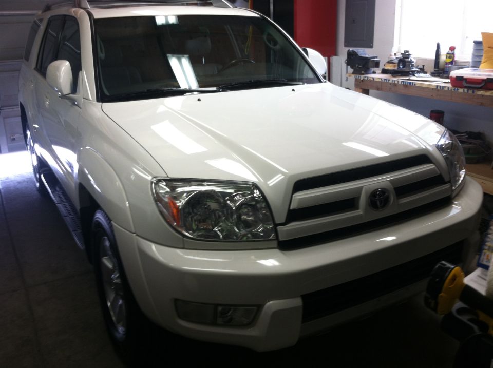 White 2003 Toyota 4Runner SUV, front 3/4 view, parked in a garage