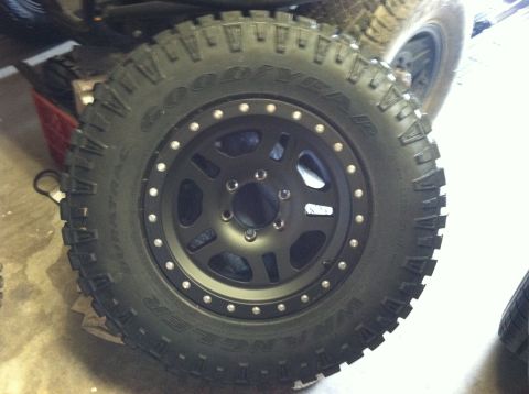 2003 Toyota 4Runner - Close-up of a Goodyear Wrangler off-road tire and black aftermarket wheel.