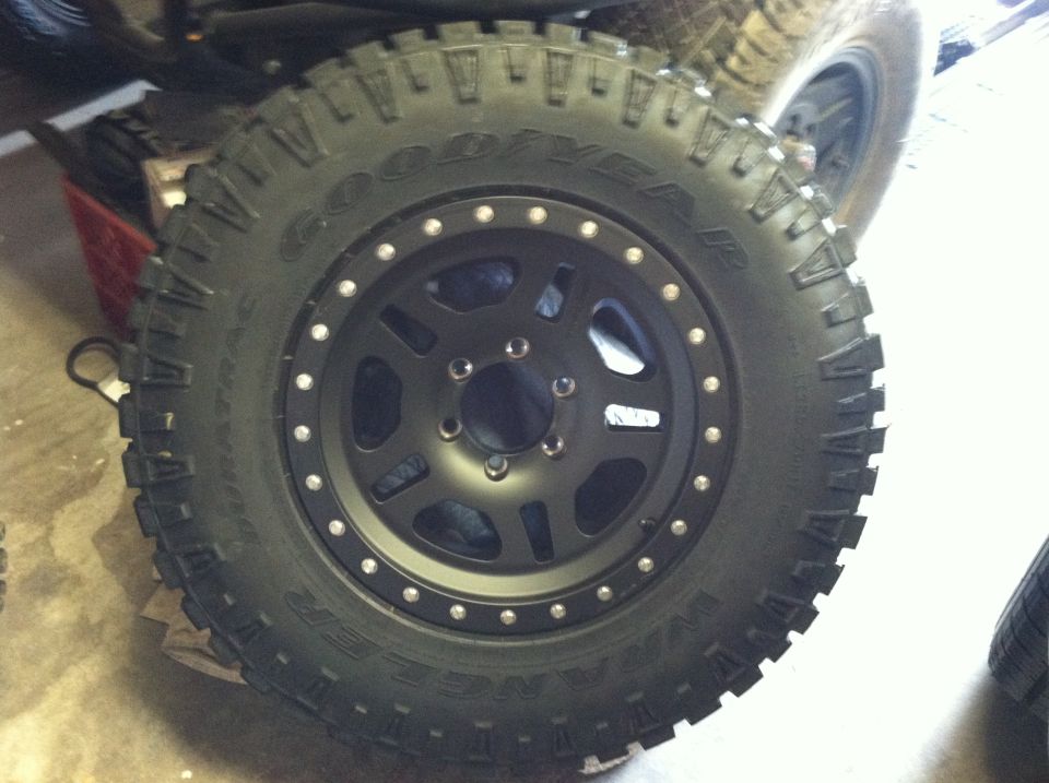 Goodyear Wrangler off-road tire mounted on a black multi-spoke wheel