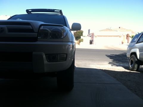 2003 Toyota 4Runner - Frontal view of a white 2003 Toyota 4Runner, parked in a driveway with another vehicle visible.