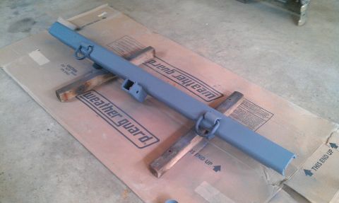 1987 Ford Bronco - This is a painted rear bumper assembly with integrated tow hitch receiver and recovery rings.
