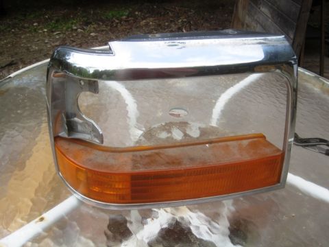 1993 Ford Bronco - This is a headlight assembly for a 1992 Ford Bronco, a chrome trim and amber turn signal.