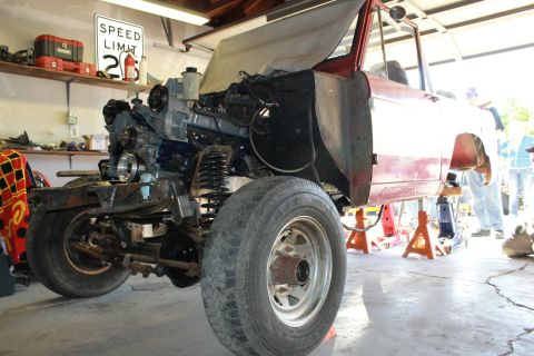 1968 Ford Bronco - This vehicle is in a garage, being worked on with the engine exposed and body raised on stands.