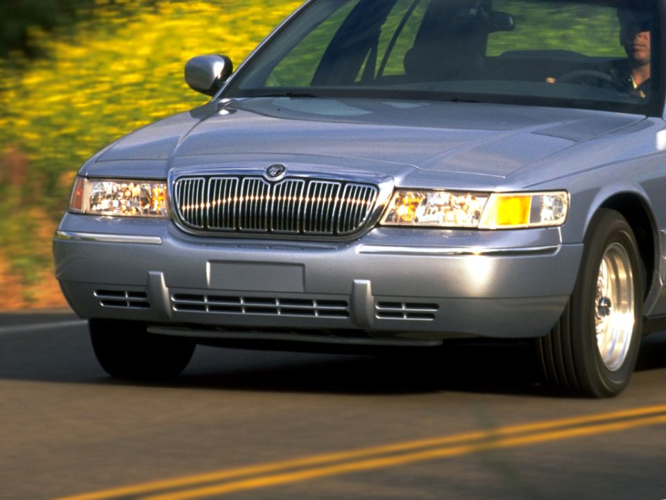 Silver Mercury Grand Marquis sedan front three-quarter view in motion on road