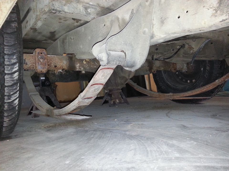 Rear leaf springs and suspension components on a vehicle supported by jack stands