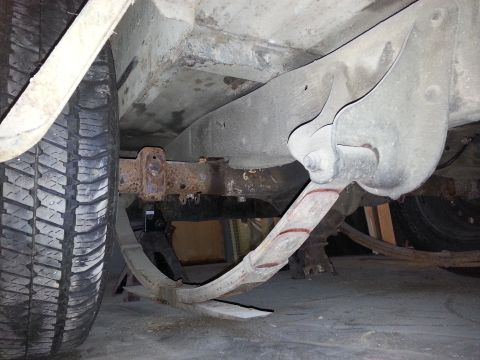 1967 Ford F-100 - Close-up view of the leaf spring suspension system, showing the spring and mounting hardware.