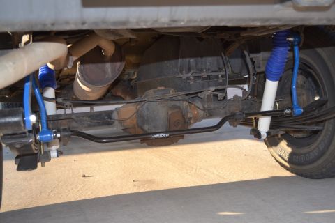 2004 Nissan Xterra - Close-up view of the rear axle and suspension system, showing aftermarket shocks and sway bar.