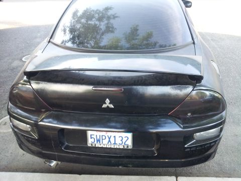 2001 Mitsubishi Eclipse - Rear view of a black 2001 Mitsubishi Eclipse, a spoiler and California license plate.