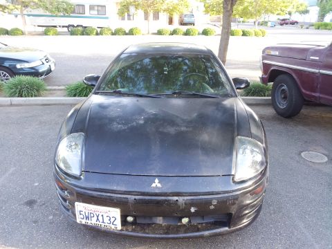 2001 Mitsubishi Eclipse - Front view of a black 2001 Mitsubishi Eclipse, showing its distinctive headlights and grille.