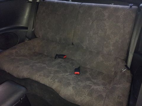 2001 Mitsubishi Eclipse - The patterned fabric on the rear seats is visible, along with the seatbelt buckles.
