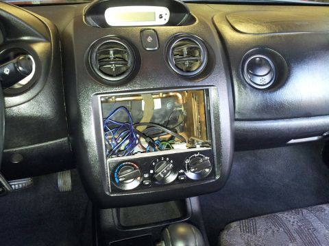 2001 Mitsubishi Eclipse - The dashboard interior shows an open radio slot with visible wiring and climate controls.