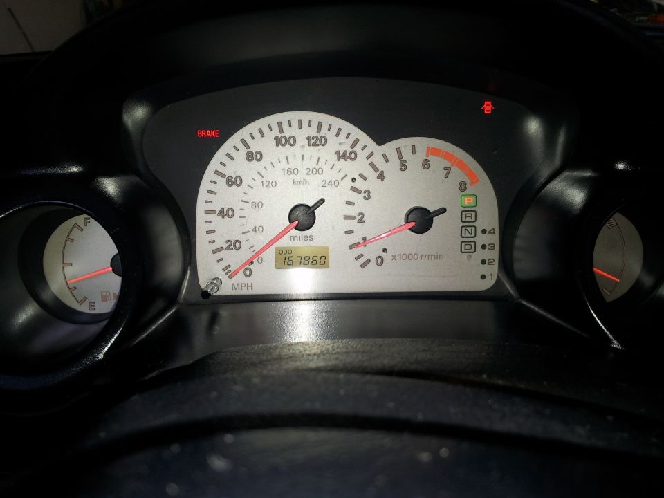 2001 Mitsubishi Eclipse dashboard with odometer showing 167860 miles