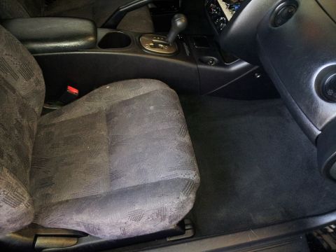 2001 Mitsubishi Eclipse - Interior view of a car, focusing on the passenger seat and center console area.