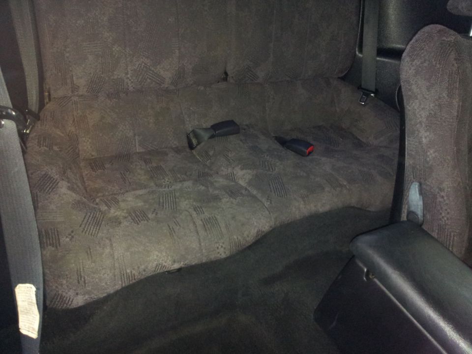 Gray patterned rear seat with seatbelts and armrest