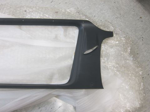 2001 Ford Crown Victoria - A dark gray car interior trim piece with cutouts is shown, wrapped in protective plastic packaging.