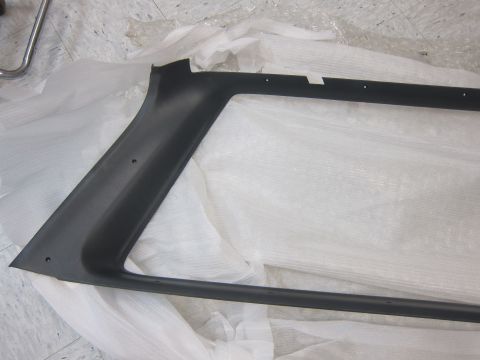 2001 Ford Crown Victoria - A black plastic trim piece is shown, likely a car part, with no visible year indicators or vehicle context.