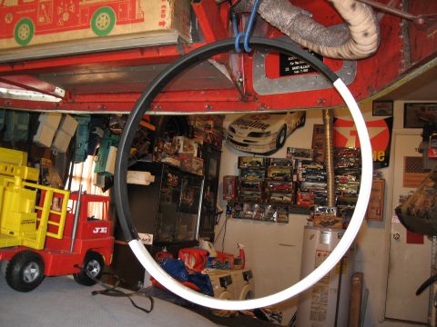 1994 Ford Bronco - A cluttered garage space displays a collection of toy vehicles and model cars on shelves.
