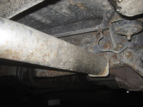 1993 Ford Bronco - This photo shows the undercarriage of a vehicle, focusing on the exhaust system and frame components.