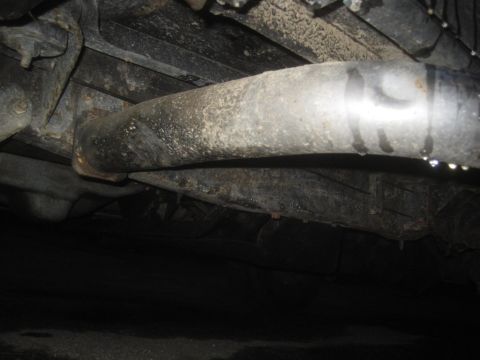 1993 Ford Bronco - Underside view of an exhaust pipe with water dripping, likely from a vehicle part-out.