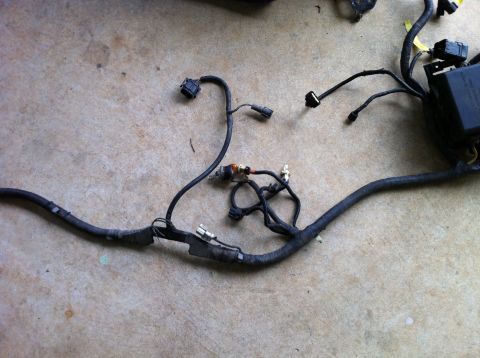 1992 Ford Bronco - A vehicle's electrical wiring harness is shown, various connectors and a fuse box.