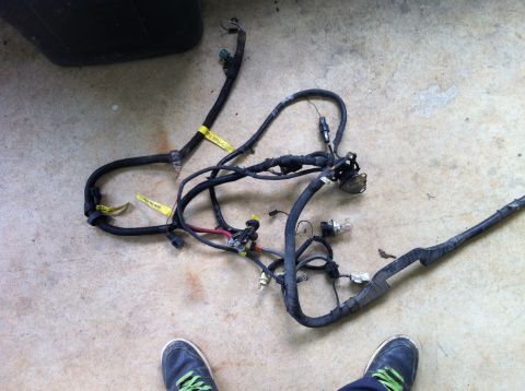 1992 Ford Bronco - A vehicle wiring harness is laid out on a concrete surface, showing various connectors and labels.