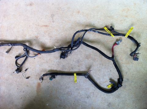 1992 Ford Bronco - This is an automotive wiring harness, likely for a Ford Bronco, laid out on a concrete surface.