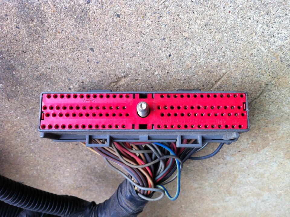 Red automotive wiring harness connector with many wires