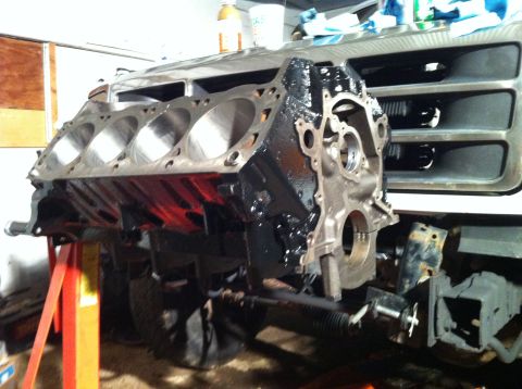 1992 Ford Bronco - Engine block being worked on, with a vehicle grille in the background.
