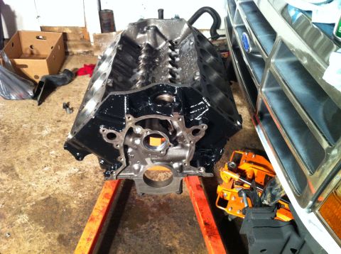 1992 Ford Bronco - Engine block and front grille of a vehicle are visible in a garage setting.