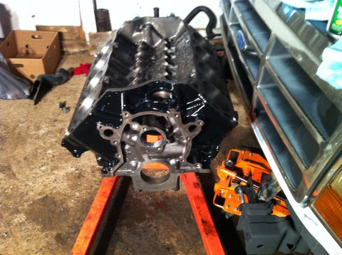 1992 Ford Bronco - Ford V8 engine block on an engine stand, with a vehicle grille in the background.