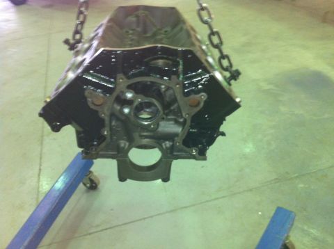 1992 Ford Bronco - Engine block hanging from chains, with a blue engine stand visible below.