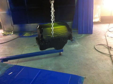 1992 Ford Bronco - Engine block being painted in a workshop environment.