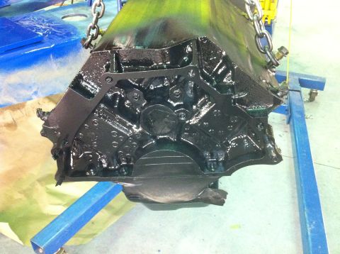1992 Ford Bronco - Engine block being worked on, suspended by chains on a blue engine stand.