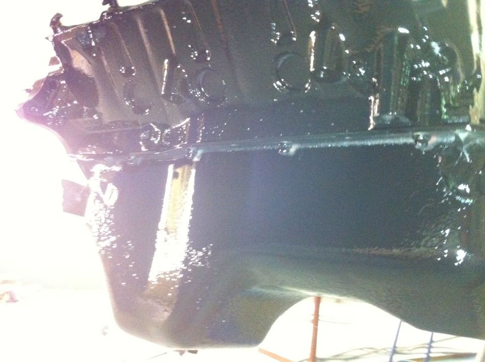Close-up of a black engine block with some shiny spots
