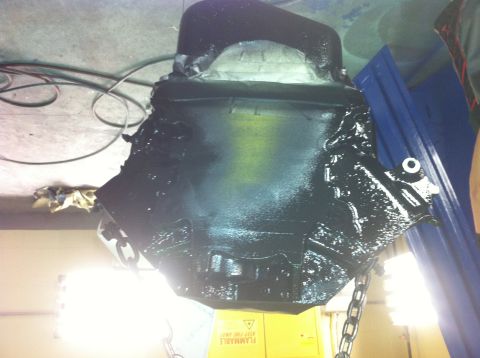 1992 Ford Bronco - Engine block is painted black and suspended by chains, likely during a rebuild or restoration process.