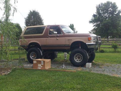 1988 Ford Bronco - This lifted Ford Bronco is supported by blocks and jacks, ready for maintenance or modification.