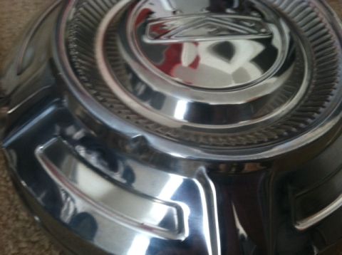 1977 Ford F-350 - A close-up view of a shiny chrome hubcap, likely from an older vehicle.