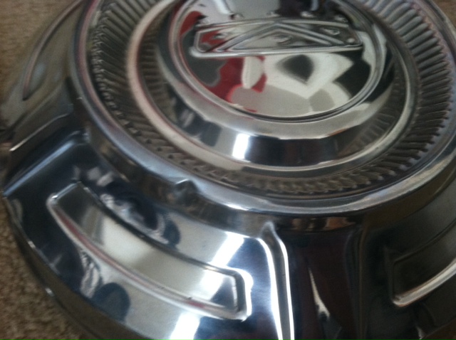 Chrome hubcap with a raised emblem