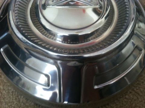 1977 Ford F-350 - Close-up of a chrome hubcap, likely from an older vehicle.