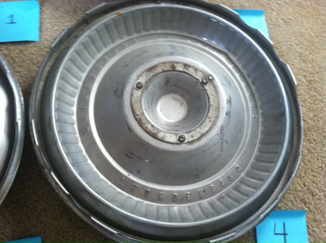 Close-up of a 1965 Ford Thunderbird hubcap with visible text