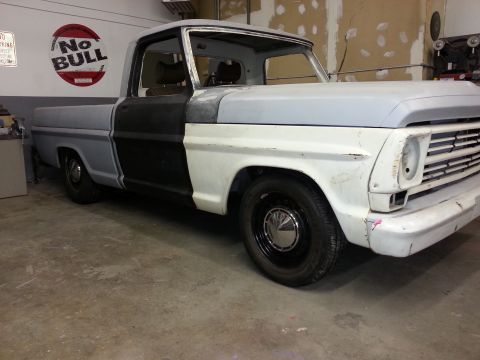 1967 Ford F-100 - This 1967 Ford F-100 pickup truck is in the process of being restored, showing primer and unfinished bodywork.