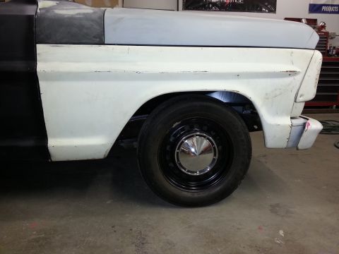 1967 Ford F-100 - Close-up of the front fender and wheel well of a classic Ford F-100 truck undergoing restoration.