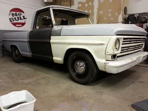 1967 Ford F-100 - This 1967 Ford F-100 pickup truck is shown in a workshop, appearing to be in the process of restoration or repair.
